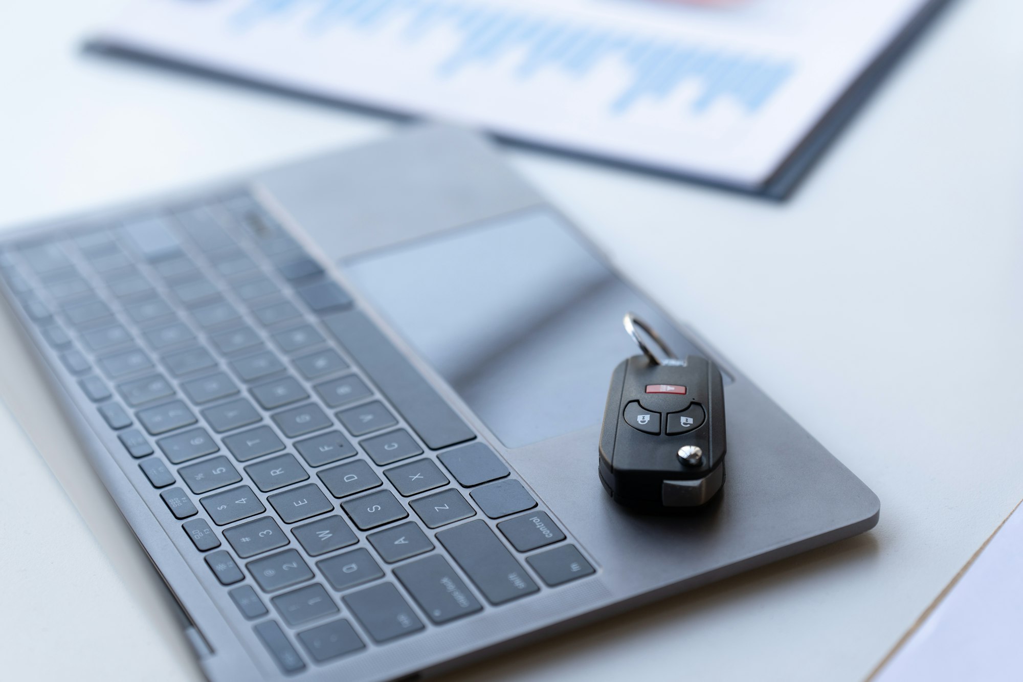 car keys placed on keyboard, car insurance concept computer